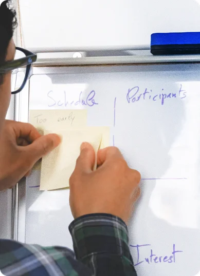 Designer sticking notes on a board.